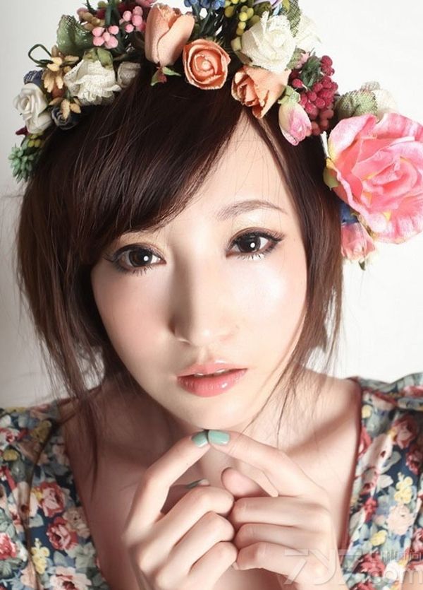 清新甜美的面容，娇嫩的肌肤惹人垂怜，穿着碎花裙子展现比本身年龄更加成熟的一面，这种裙子也只能是这个年龄的女人穿才能穿出感觉。头戴花圈非常的有特色，波西米亚风格，很美丽。